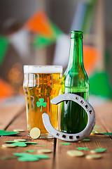 Image showing glass of green beer, horseshoe and gold coins