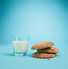 Image showing Glass of milk and oatmeal cookies. Morning dessert