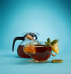 Image showing The herbal tea on a blue background