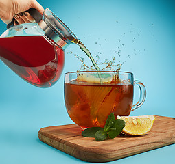 Image showing The herbal tea on a blue background
