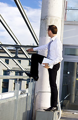 Image showing handsome businessman with laptop computer on a building site