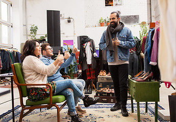 Image showing friends choosing clothes at vintage clothing store