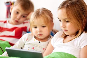 Image showing little kids with tablet pc in bed at home