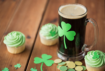 Image showing shamrock on glass of beer, green cupcakes and coins