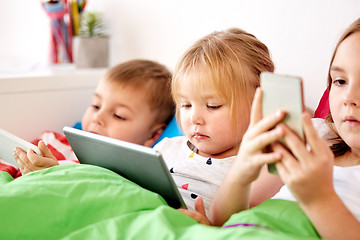 Image showing little kids with tablet pc in bed at home