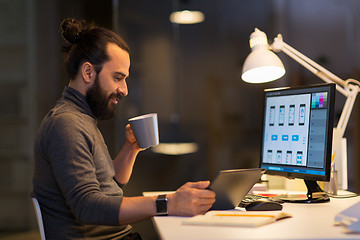 Image showing creative man with computer working late at office