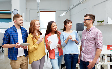 Image showing happy creative team drinking coffee at office