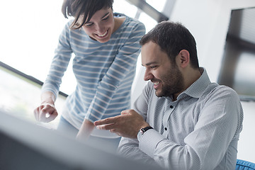 Image showing Two Business People Working With Tablet in startup office