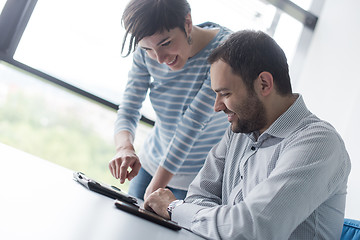 Image showing Two Business People Working With Tablet in startup office