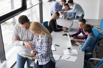 Image showing Two Business People Working With Tablet in office