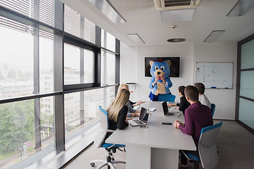 Image showing boss dresed as bear having fun with business people in trendy of