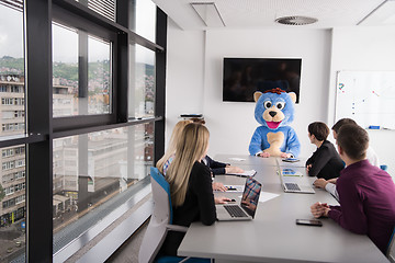 Image showing boss dresed as bear having fun with business people in trendy of