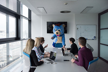 Image showing boss dresed as bear having fun with business people in trendy of