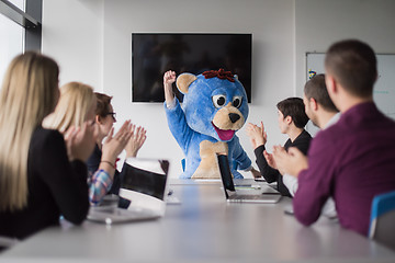 Image showing boss dresed as bear having fun with business people in trendy of