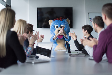 Image showing boss dresed as bear having fun with business people in trendy of