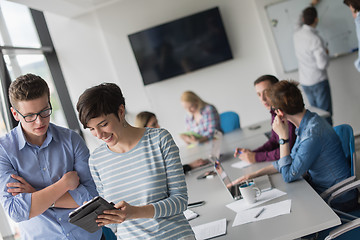 Image showing Two Business People Working With Tablet in office