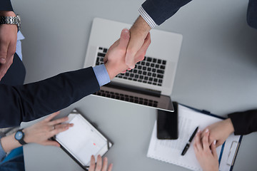 Image showing cloasing the deal in modern office interior top view