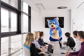 Image showing boss dresed as bear having fun with business people in trendy of