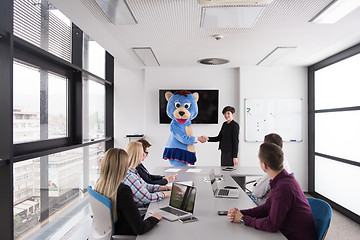 Image showing boss dresed as bear having fun with business people in trendy of