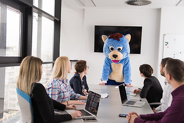 Image showing boss dresed as bear having fun with business people in trendy of