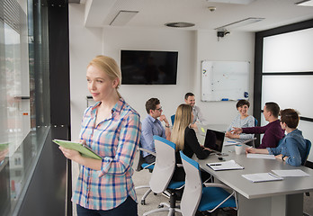 Image showing Pretty Businesswoman Using Tablet In Office Building by window