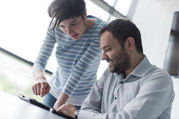 Image showing Two Business People Working With Tablet in startup office