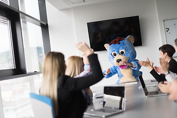 Image showing boss dresed as bear having fun with business people in trendy of