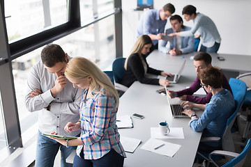 Image showing Two Business People Working With Tablet in office