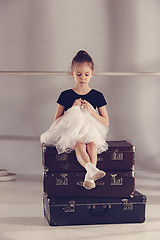 Image showing The little girl as balerina dancer sitting at studio