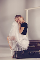 Image showing The little girl as balerina dancer sitting at studio