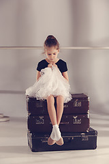 Image showing The little girl as balerina dancer sitting at studio