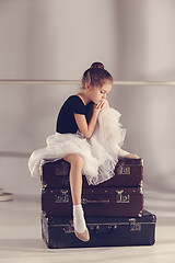 Image showing The little girl as balerina dancer sitting at studio