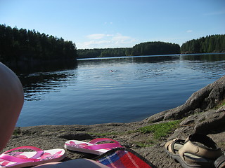 Image showing Sunbathing by a small lake