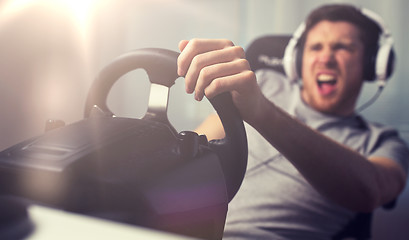 Image showing close up of man playing car racing video game