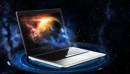 Image showing laptop with virtual planet and space hologram