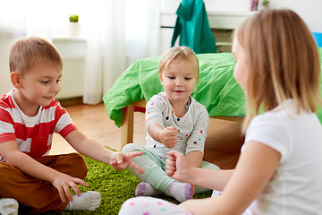 Image showing kids playing rock-paper-scissors game at home