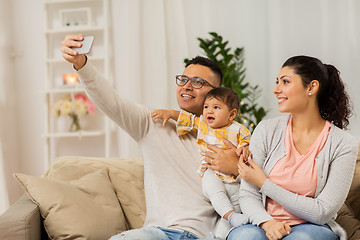 Image showing mother and father with baby taking selfie at home