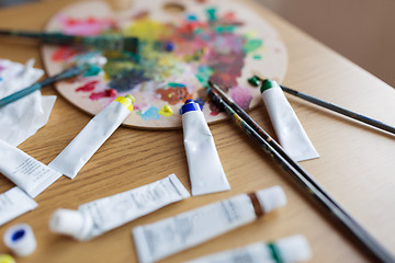 Image showing palette, brushes and paint tubes on table