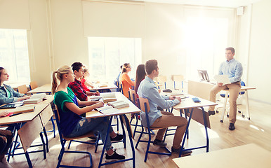 Image showing group of students and teacher with papers or tests