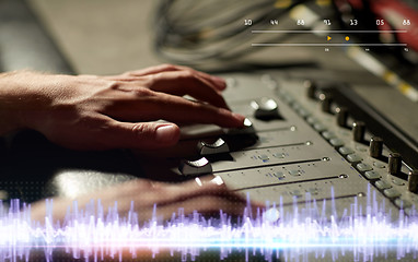 Image showing hands on mixing console in music recording studio