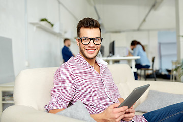 Image showing man in glasses with tablet pc working at office