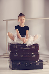 Image showing The little girl as balerina dancer sitting at studio