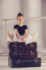 Image showing The little girl as balerina dancer sitting at studio