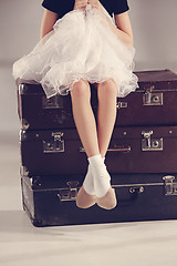 Image showing The little girl as balerina dancer sitting at studio