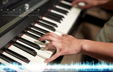 Image showing hands playing piano at sound recording studio