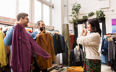 Image showing friends photographing at vintage clothing store