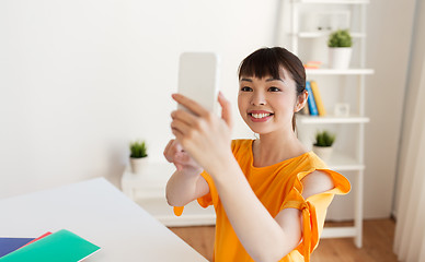 Image showing student girl taking selfie by smartphone at home