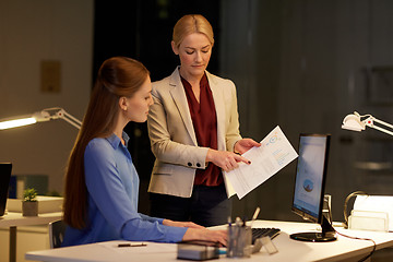 Image showing businesswomen with computer working late at office