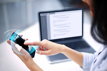 Image showing businesswoman with smartphone and earth hologram