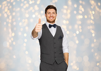 Image showing happy man in festive suit showing thumbs up